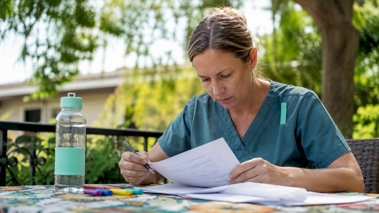 Nurse reviewing schedules in break room